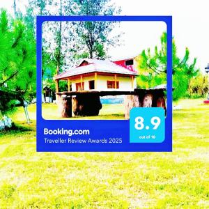 a picture of a house in a field at Wooden Attic cottage in Pori