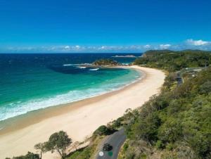 an aerial view of a beach and the ocean at Sandbar views in Smiths Lake