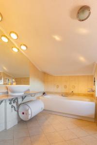 a large bathroom with a tub and a sink at Downtown Bansko Resort in Bansko