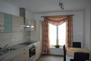 a kitchen with a table and a window and a table and a dining room at Ferienwohnung zur Stadtmauer in Bad Bergzabern