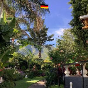 a garden with a flag flying in the sky at Bollinger Guest House in George