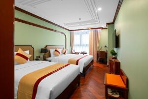 a hotel room with two beds and a window at 12 A&B Điện Biên Phủ Hà Nội Hotel in Hanoi