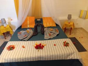 a bedroom with a bed with towels on it at Bungalow La Marina in Le Marin +4 photos