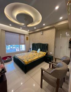 a bedroom with a large bed and a ceiling at Homely stay 3 in Kharar