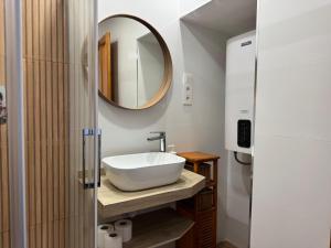 a bathroom with a white sink and a mirror at Apartamento Corredera in Córdoba