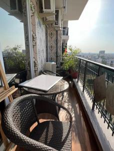 a balcony with a table and chairs on a balcony at Homely stay 3 in Kharar
