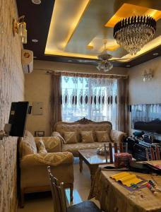 a living room with a couch and a table at Homely stay 3 in Kharar