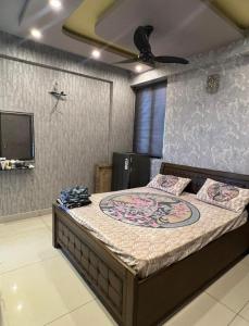 a bedroom with a large bed with a ceiling at Homely stay 3 in Kharar