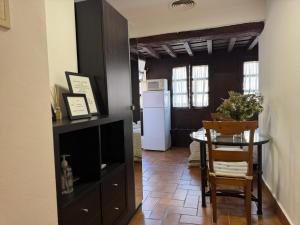 a kitchen and dining room with a table and a refrigerator at Apartamento Corredera in Córdoba