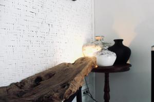 a table with two vases on it next to a wall at Dwipa Peaceful, spacious 2 bedroom villa in Sanur