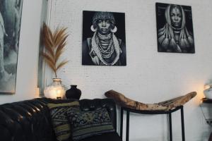 a living room with three pictures on the wall at Dwipa Peaceful, spacious 2 bedroom villa in Sanur +26 photos