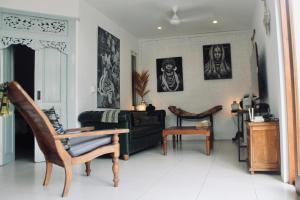 a living room with a couch and a chair at Dwipa Peaceful, spacious 2 bedroom villa in Sanur