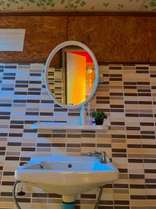 a bathroom with a mirror and a sink at Rakkhao Inthanon homestay LoveInthanon in Ban Yang Di Pha Mop