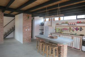 a kitchen with a large table and some chairs at Posada María E in Mucuchíes