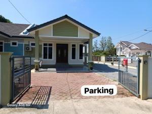 a house with a gate and the words parking at Sofiyyah Homestay in Tumpat