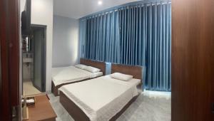 Postel nebo postele na pokoji v ubytování Kim Mau Motel + 16 fotografií