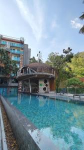 a large swimming pool with a building in the background at Emerald Terrace Resort 2 bedrooms Panoramic Ocean View Top Floor in Patong Beach