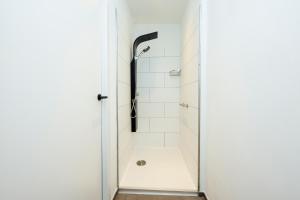 a shower in a white bathroom with a glass door at Zeedijk 237 Middelkerke in Middelkerke +23 photos