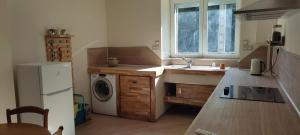 a kitchen with a sink and a washing machine at Gite bord riviere volane in Vals-les-Bains