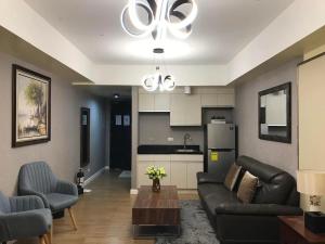 a living room with a couch and a table at Davao Central Suites in Davao City