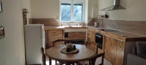 a kitchen with a table and chairs and a sink at Gite bord riviere volane in Vals-les-Bains