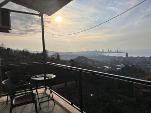 a balcony with a table and chairs and a view of the city at House for rest in Batumi