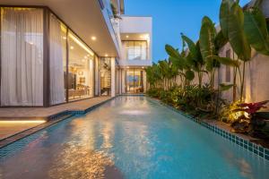 a swimming pool in the middle of a house at Kim Son Pool Villa Da Nang in Da Nang