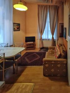 a living room with a couch and a table at Delux Kolonada in Karlovy Vary