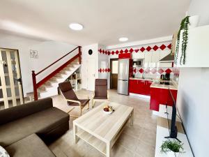 a living room with a couch and a table at Sunny Monaco Puerto Rico in Mogán