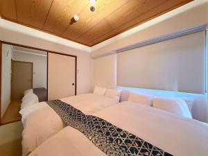 Ένα ή περισσότερα κρεβάτια σε δωμάτιο στο Residence Yu - Spacious 2BR Apartment Central Yet Peaceful Stay