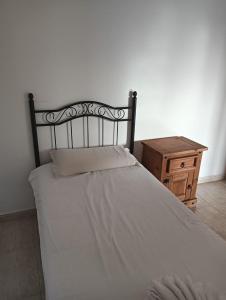 a bedroom with a white bed and a wooden table at Sweet Luxury Rooms in Rome +4 photos