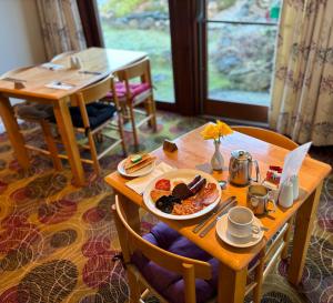 a table with a plate of breakfast food on it at The Brae Hotel in Brae