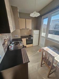 a kitchen with a black counter top in a room at Apartment Mladost 1 in Sofia