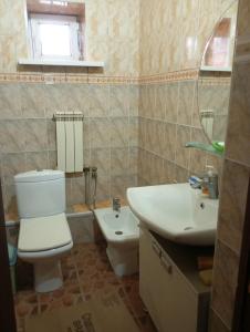 a bathroom with a toilet and a sink at happy home in Bishkek