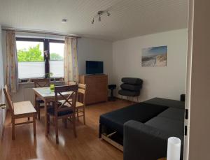 a living room with a bed and a dining room at Ferienwohnung Wittmoldt bei Plön in Wittmoldt