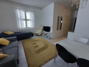 a living room with a couch and a table at Royal Katariina in Kokkola
