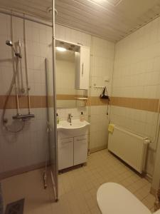 a bathroom with a shower and a sink at Royal Katariina in Kokkola