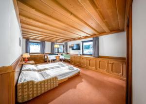 a large bedroom with a large bed in a room at Villa Pana in Santa Cristina Gherdëina +12 photos