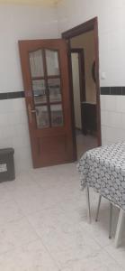 a room with a door and a bench and a table at BASAURI, céntrico, metro in Basauri +8 photos