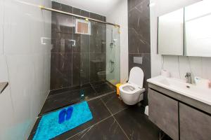 a bathroom with a shower and a toilet and a sink at Luxury 3br Ensuite Apt in Prestigious Nyali in Mombasa +11 photos