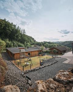 a building with a playground in front of it at Ferienhaus Nina am Riedener Waldsee in Rieden