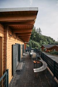 a patio with a table and benches on a building at Ferienhaus Nina am Riedener Waldsee in Rieden