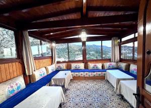 una stanza con divani e tavoli in una stanza con finestre di Hôtel Koutoubia a Chefchaouen