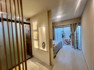 a room with a bed and a door with a balcony at Villa Darius in Cabo Frio +6 photos