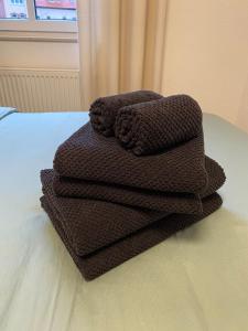 a pile of brown towels sitting on a table at Cosy-Chic Apartment in Eisenach