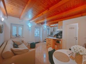 a living room with a couch and a table at Dubrovnik house - Leni in Komolac +18 photos