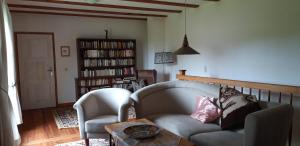 a living room with a couch and two chairs and a table at 160 qm große Ferienwohnung für 5 Personen nahe Stettiner Haff in Bugewitz