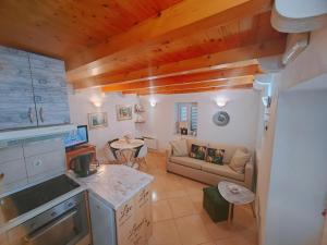 a kitchen and living room with a couch and a table at Dubrovnik house - Leni in Komolac