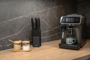 a coffee maker on a counter next to a coffee machine at Apartmán DANIEL in Spišská Nová Ves