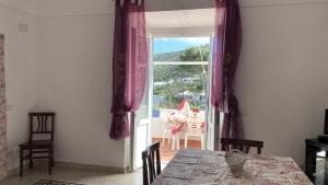 a dining room with a table and a sliding glass door at Ponzamania Da Cecilia in Ponza